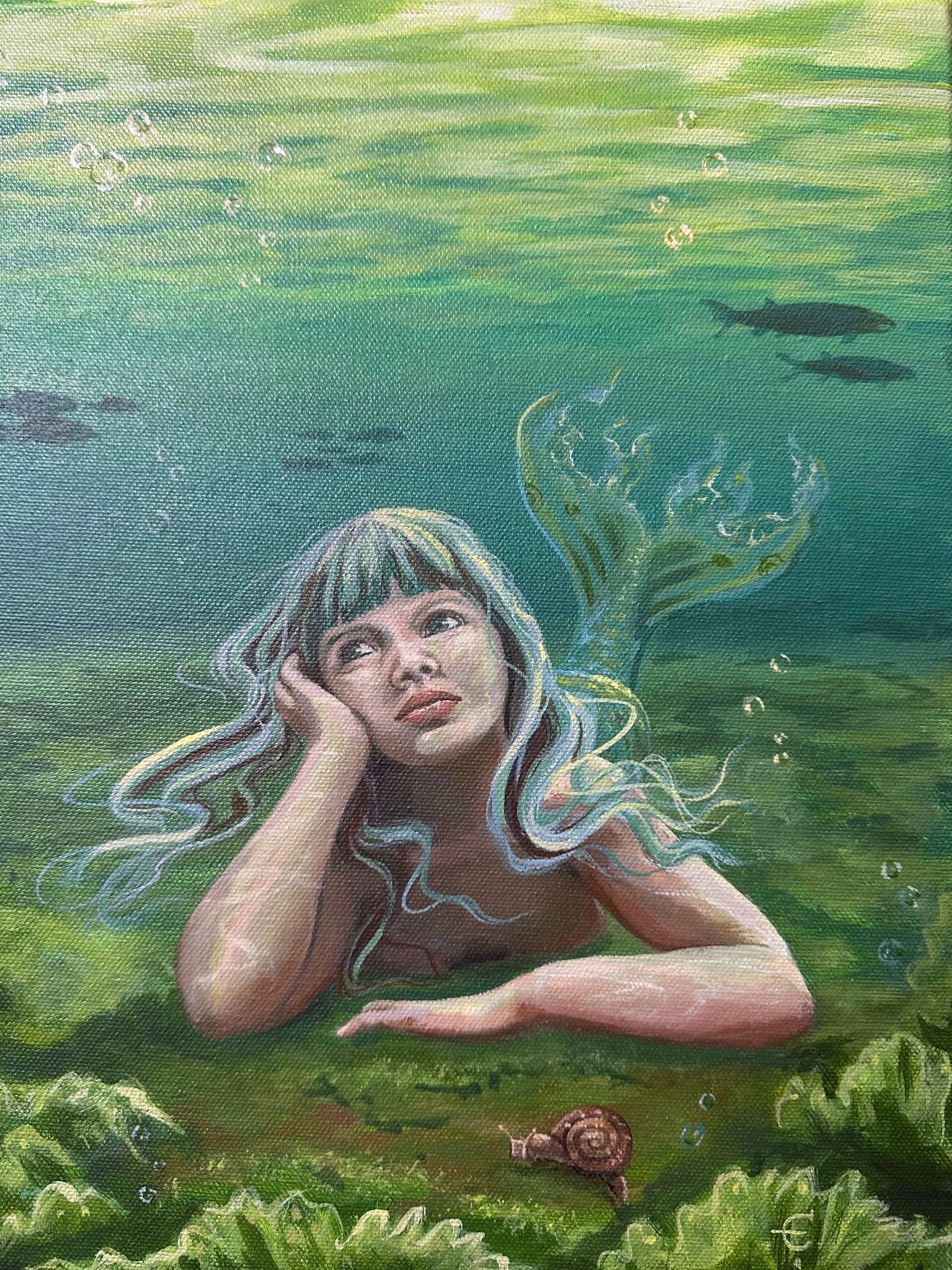 A contemplative young mermaid rests on the sea floor as salmon swim in the background and snail crawls before her.